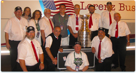 Group of sports fans in front of Lorenz bus 